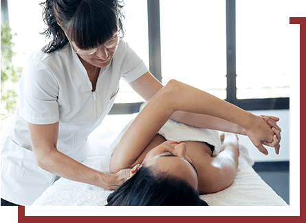 A chiropractor adjusting a woman's shoulder