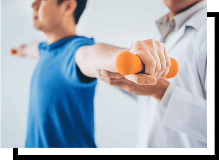 A physical therapist working with a man using small weights