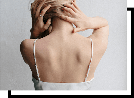 The back of a woman wearing a white tank top
